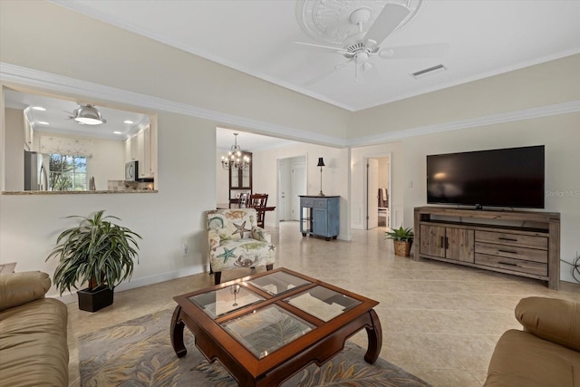 living room featuring crown molding and ceiling fan with notable chandelier