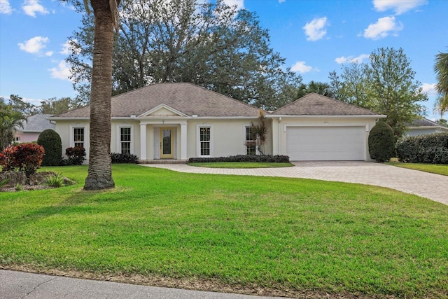 view of front facade with a garage and a front lawn