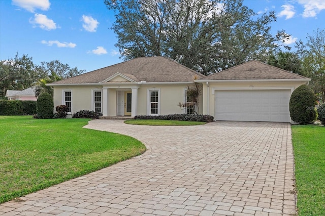 ranch-style home with a garage and a front lawn