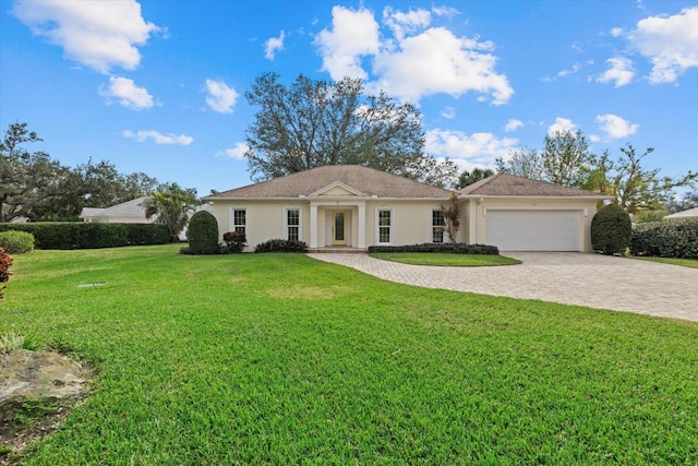 single story home featuring a garage and a front yard