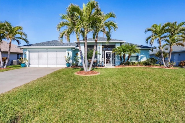 single story home with a garage, central AC, and a front yard