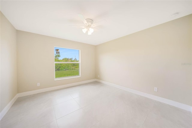 tiled spare room with ceiling fan