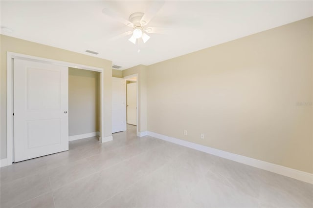 unfurnished bedroom featuring light tile patterned flooring, ceiling fan, and a closet