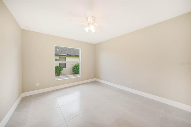 tiled empty room with ceiling fan