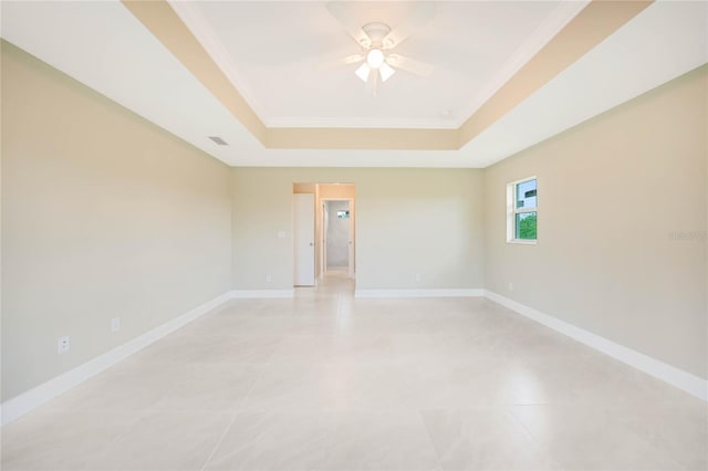 unfurnished room featuring ornamental molding, a raised ceiling, and ceiling fan