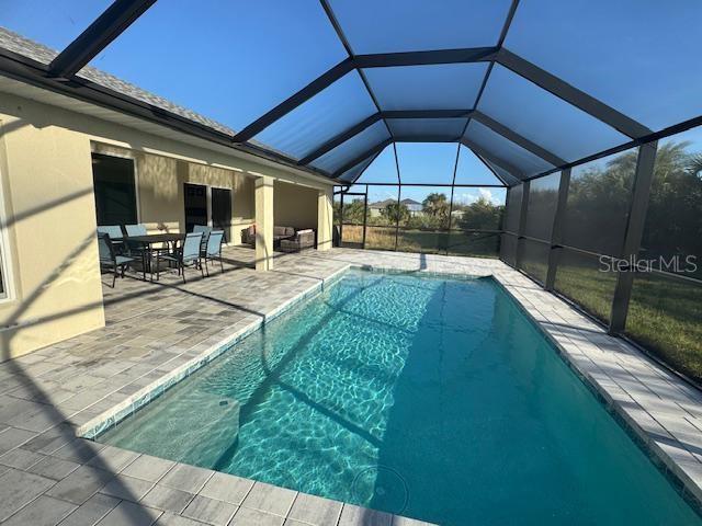 view of pool featuring a lanai and a patio area