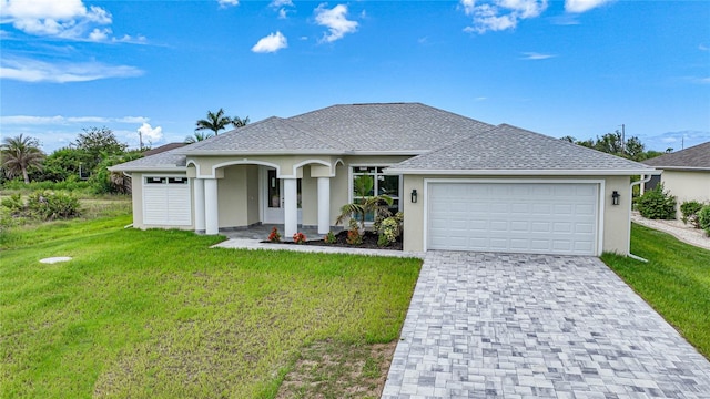 view of front of house with a garage and a front yard