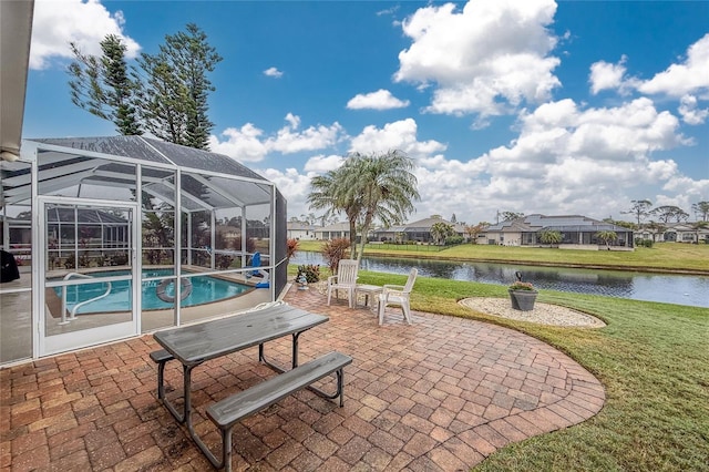 view of patio featuring a water view and glass enclosure