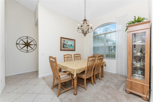 tiled dining area featuring a notable chandelier