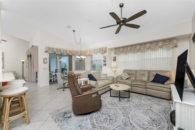 living room featuring light tile patterned flooring, lofted ceiling, and ceiling fan with notable chandelier