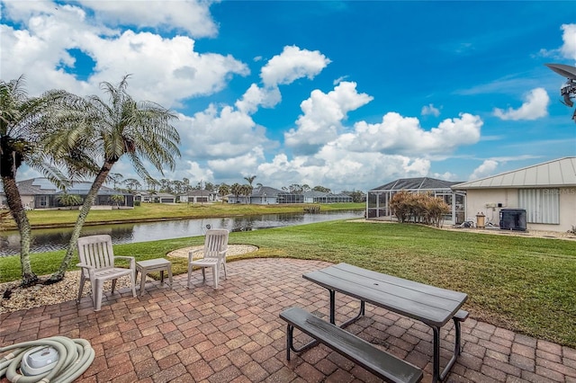 view of patio / terrace featuring a water view, a lanai, and cooling unit