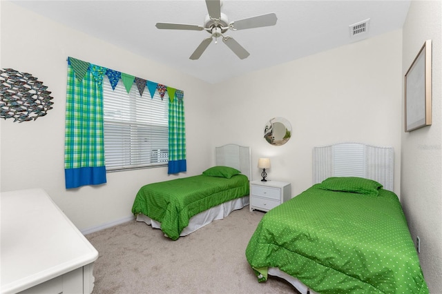 bedroom featuring ceiling fan and light carpet