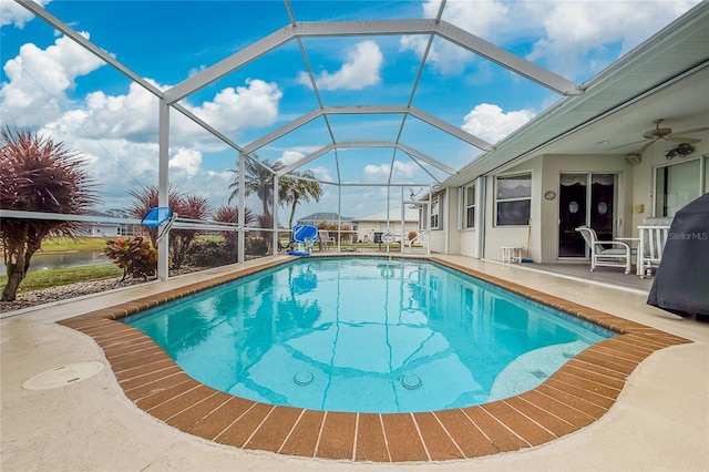 view of swimming pool featuring a patio and a lanai