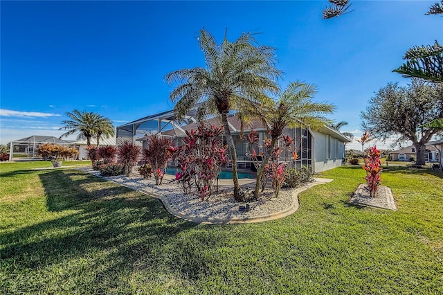 view of yard featuring a pool and a lanai