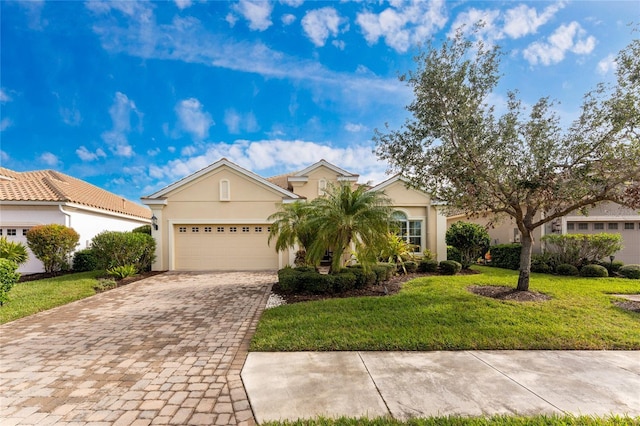 view of front of home with a garage and a front lawn