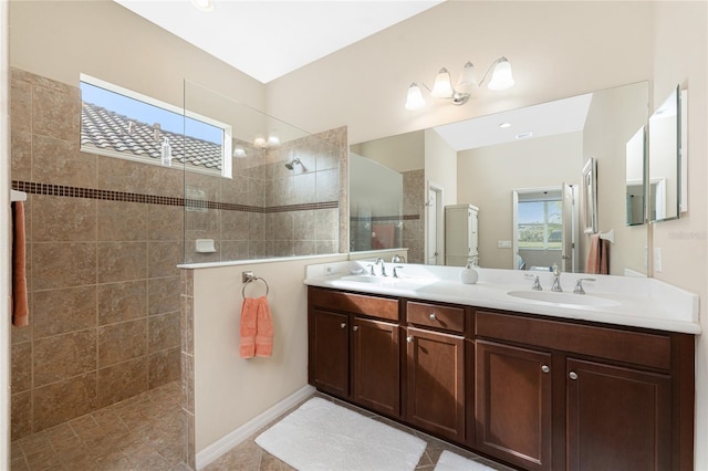 bathroom featuring vanity and tiled shower