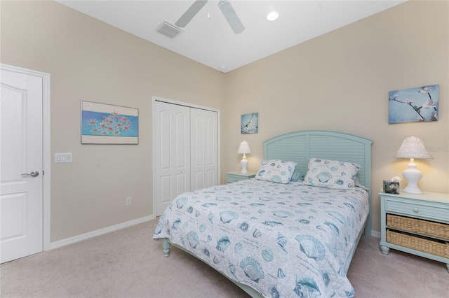 carpeted bedroom with ceiling fan and a closet