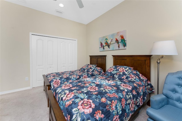 bedroom with ceiling fan, light colored carpet, and a closet