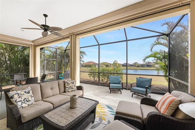 sunroom featuring a water view and ceiling fan