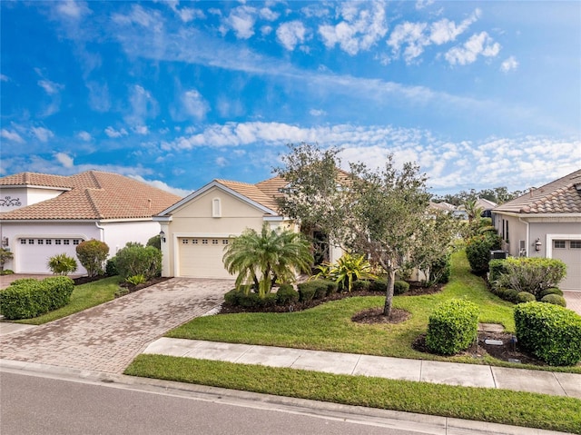 view of front of house featuring a garage and a front lawn