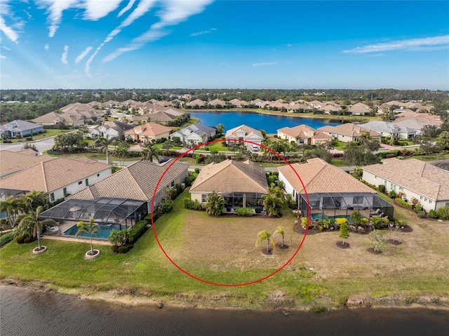 birds eye view of property with a water view