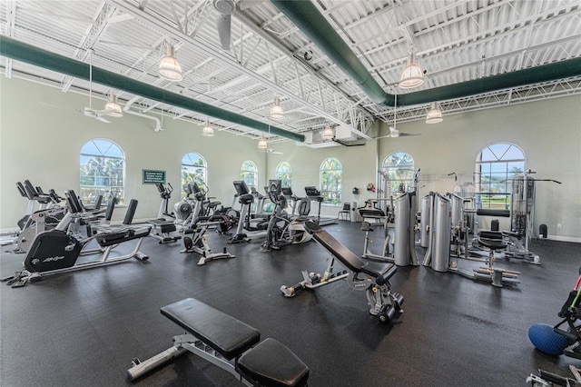 gym with a towering ceiling and a healthy amount of sunlight