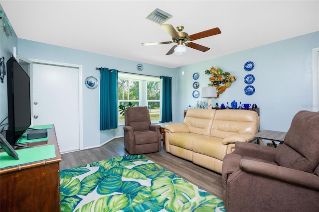 living room with ceiling fan and dark hardwood / wood-style floors