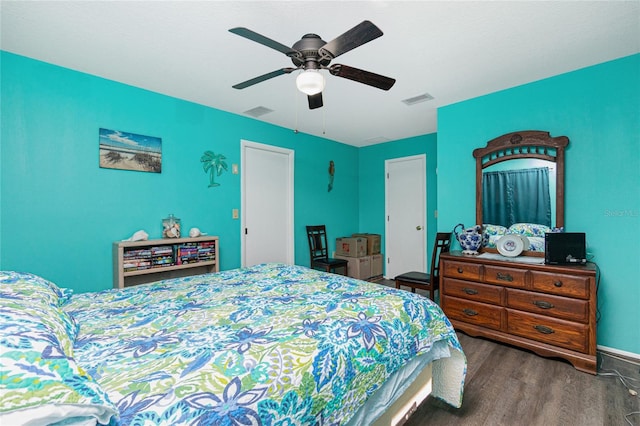 bedroom with ceiling fan and dark hardwood / wood-style flooring