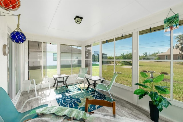 sunroom / solarium featuring a healthy amount of sunlight