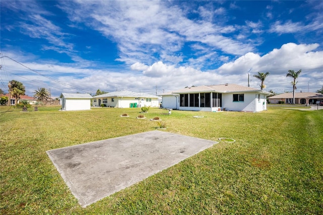 rear view of property with a patio, a sunroom, and a lawn