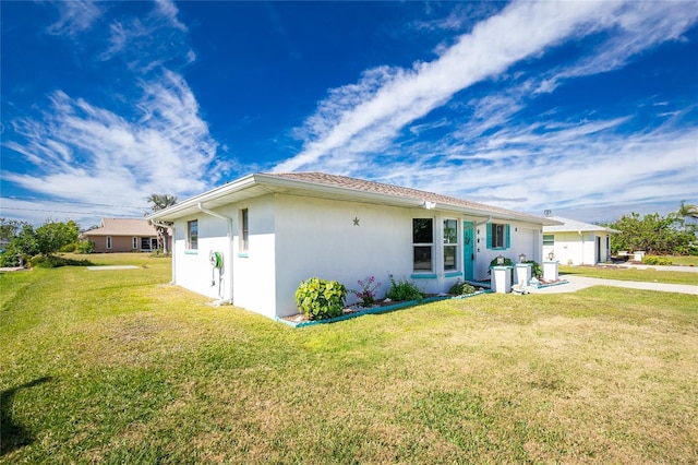 view of property exterior featuring a lawn