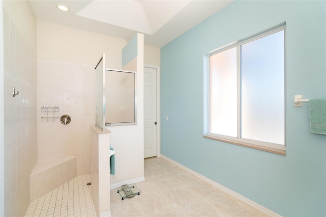 bathroom with a tile shower