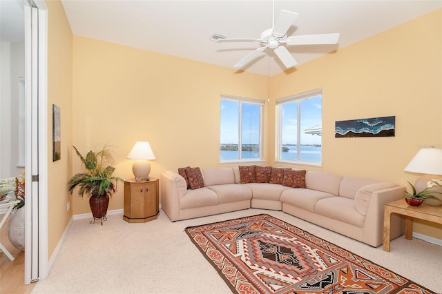 living room featuring a water view and ceiling fan