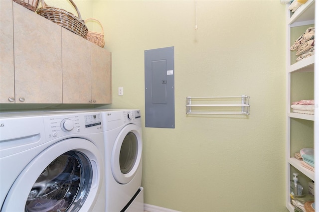 laundry room featuring cabinets, washer and dryer, and electric panel