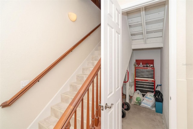 stairway featuring concrete flooring