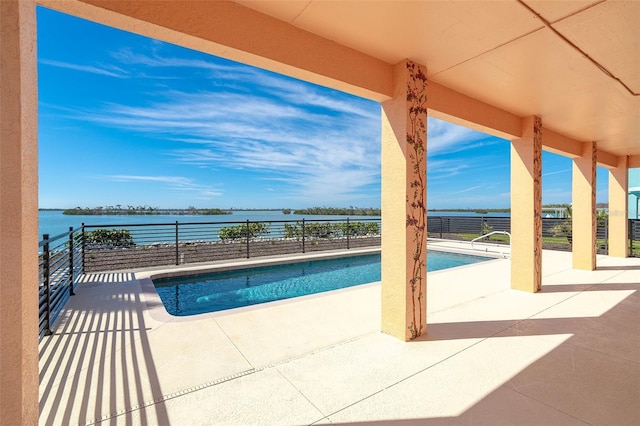 view of pool with a water view and a patio