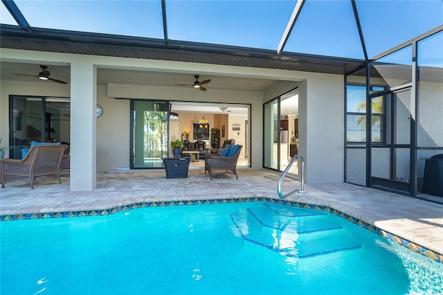 view of swimming pool with ceiling fan, an outdoor living space, glass enclosure, and a patio area