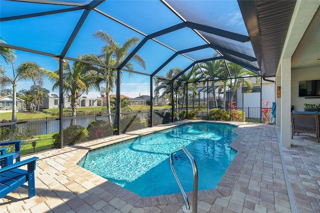 view of pool featuring a patio, a water view, and glass enclosure