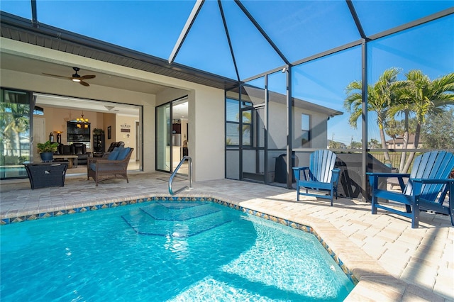 view of pool featuring a patio area, ceiling fan, and glass enclosure