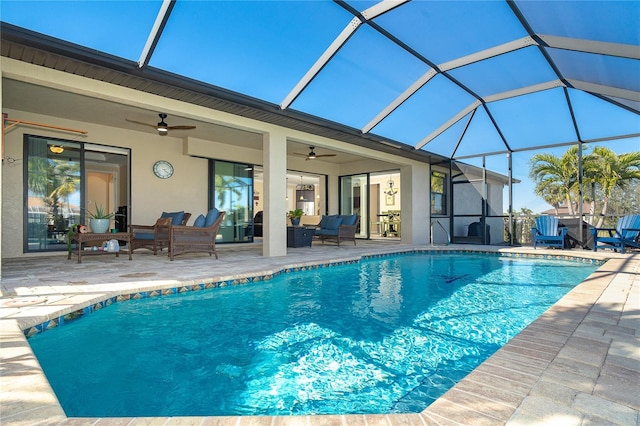 view of pool with an outdoor living space, a patio, ceiling fan, and glass enclosure