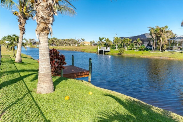 dock area featuring a lawn and a water view