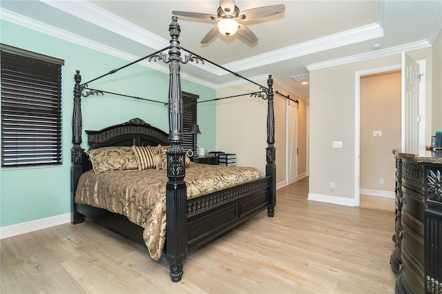 bedroom featuring crown molding, light hardwood / wood-style flooring, and ceiling fan