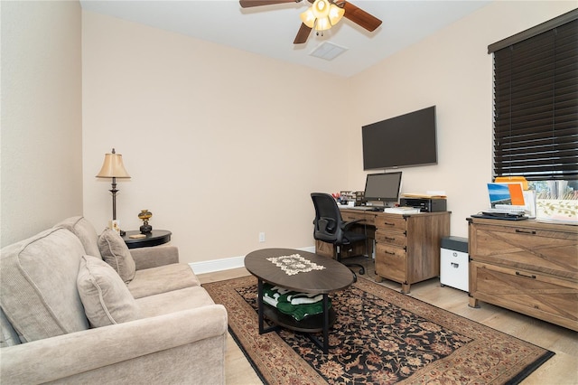 office space with light hardwood / wood-style floors and ceiling fan