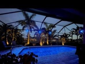214 W Pine Valley Ln, Rotonda West, FL 33947 - outdoor pool featuring glass enclosure