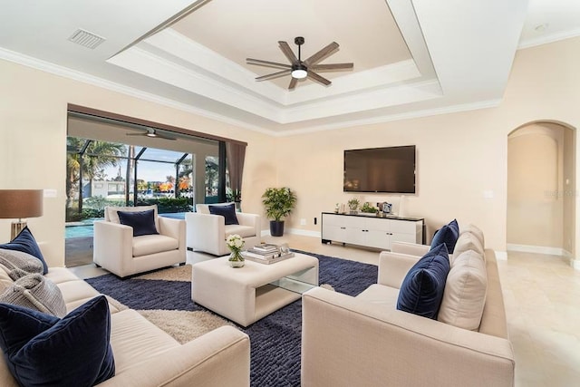 214 W Pine Valley Ln, Rotonda West, FL 33947 - living room featuring a tray ceiling, arched walkways, visible vents, baseboards, and ceiling fan