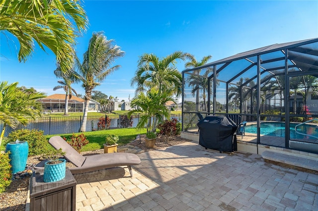 214 W Pine Valley Ln, Rotonda West, FL 33947 - view of patio with glass enclosure, fence, a water view, and a fenced in pool