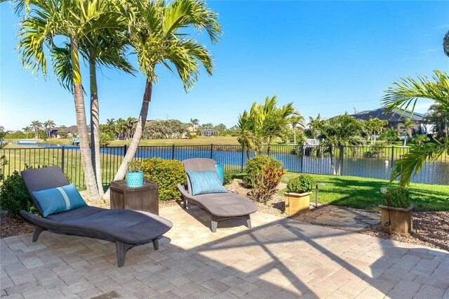 214 W Pine Valley Ln, Rotonda West, FL 33947 - view of patio / terrace featuring fence and a water view