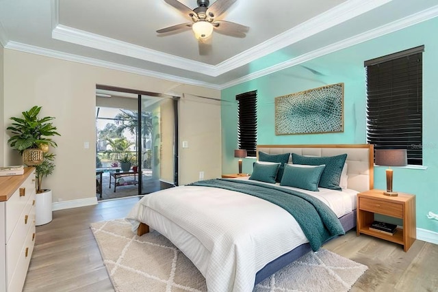 214 W Pine Valley Ln, Rotonda West, FL 33947 - bedroom with crown molding, baseboards, light wood-style floors, and access to exterior