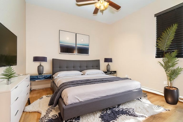 214 W Pine Valley Ln, Rotonda West, FL 33947 - bedroom featuring ceiling fan, baseboards, and light wood-type flooring