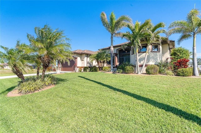 214 W Pine Valley Ln, Rotonda West, FL 33947 - view of front facade with a front yard and stucco siding